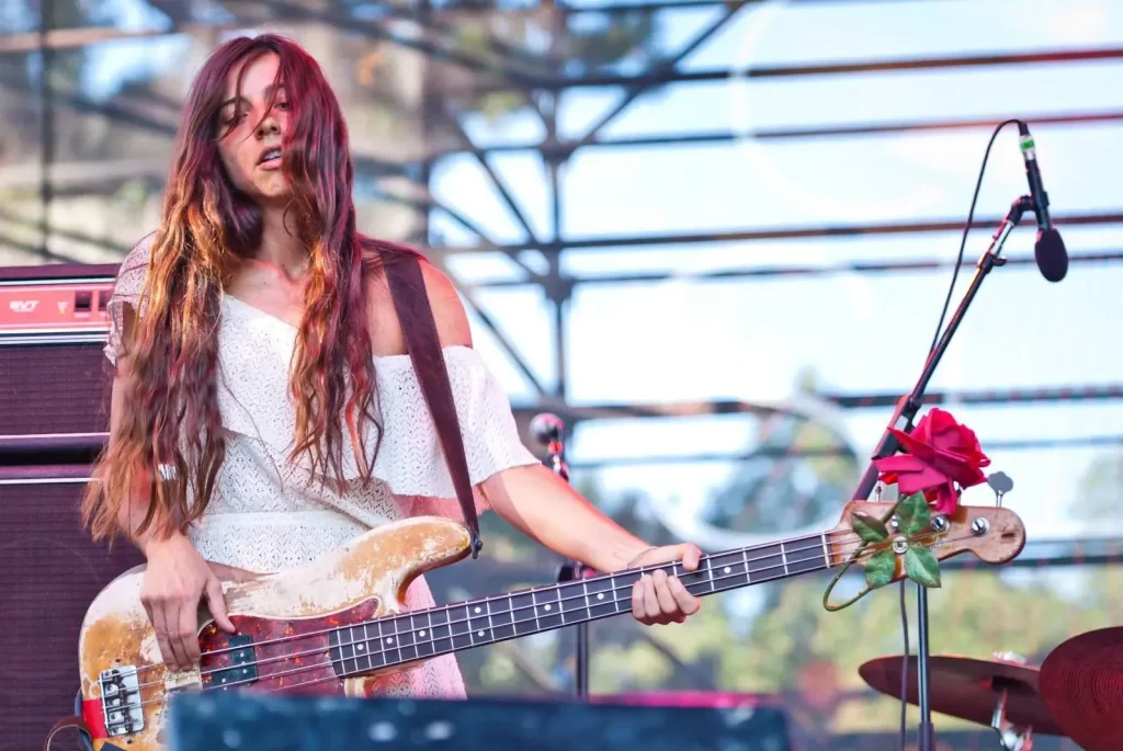 A perfect circle bassist with her bass with flower